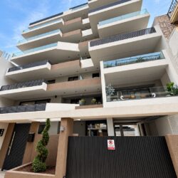 Contemporary facade of Faros Residences in Chalkida with geometric balconies, glass railings and aluminium elements
