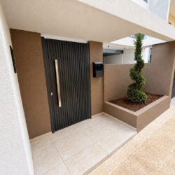 Anthracite aluminium entrance gate at Faros Residences in Chalkida with modern vertical profiles and landscaped entrance